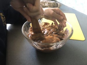stirring cherries into melted chocolate